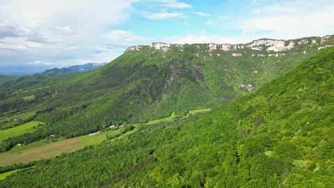 Panoramic drone view of tree-covered hillsides of the heights of the Vercors Stock Footage 242724074