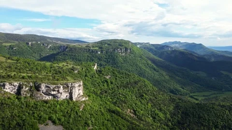 Panoramic drone view of tree-covered hillsides of the heights of the Vercors Stock Footage 242724194