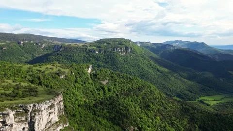Panoramic drone view of tree-covered hillsides of the heights of the Vercors Stock Footage 242724212