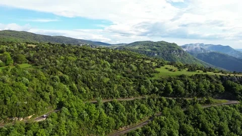Panoramic drone view of tree-covered hillsides of the heights of the Vercors Stock Footage 242724892