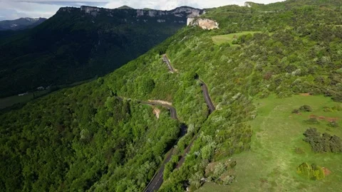 Panoramic drone view of tree-covered hillsides of the heights of the Vercors Stock Footage 242724956