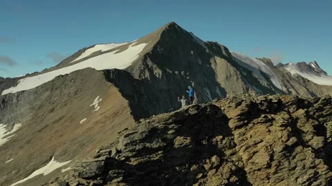 Panoramic drone view of two men in mountains near Elbrus. Stock Footage 138577451