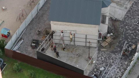 Panoramic drone view of workers assembling roof frame Stock Footage 340610705