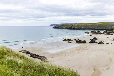 Panoramic Durness Beach, waves, sand and striking rocks along the shore. Stock Photos
