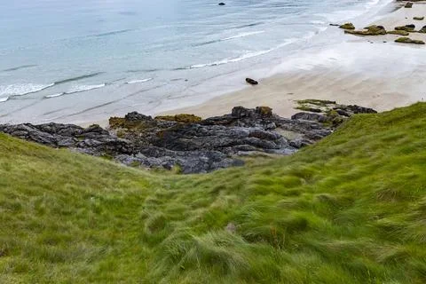 Panoramic Durness Beach, waves, sand and striking rocks along the shore. Stock Photos