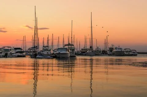 Panoramic evening view of the seaport at sunset Stock Photos