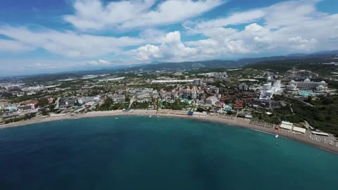 Panoramic FPV Drone Flight Over Coastal Resort and Beachfront Stock Footage 309038786