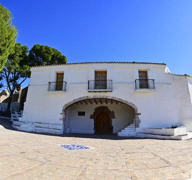 Panoramic front view of Ermita de la Magdalena among pine trees and its tiled Stock Photos