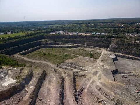 Panoramic high angle drone view of deep open pit industrial stone quarry Fotos Stock