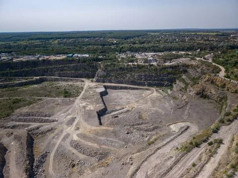 Panoramic high angle drone view of active granite stone quarry and mining sit Fotos Stock