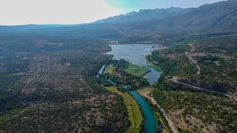 Panoramic high-angle shot showcasing the confluence of a vibrant river Stock Photos