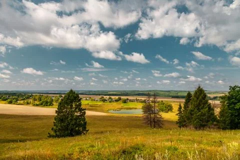 Panoramic high angle view of the plain, the village and the lake from hill to Stock Photos