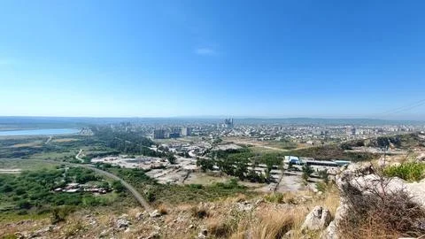 Panoramic High Angle View of Sprawling City and Blue Lake Stock Photos