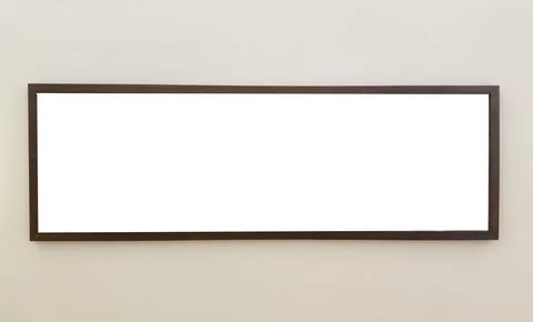 Panoramic horizontal picture frame hangs on beige wall in modern interior. Stock Photos