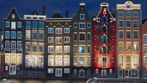 Panoramic of the iconic illuminated famous Dancing Houses along the Amstel River Stock Footage 317587321