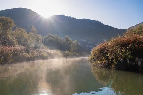Panoramic idyllic view of water reflection in Crmnica river going to Lake S.. Stock Photos