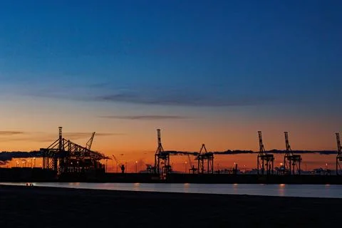 Panoramic image of the cargo port at sunset. Gdansk at night with container Stock Photos