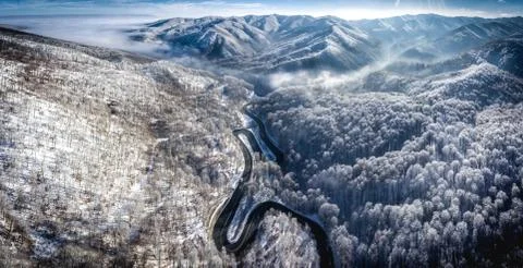 Panoramic image of a winding road from a high mountain pass in Transylvania i Stock Photos