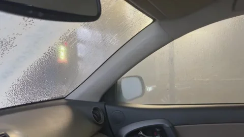 Panoramic interior view of car with foam covering windows, Concept of wash Stock Footage 344248487