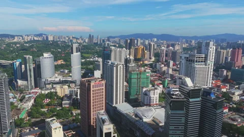 Panoramic Kuala Lumpur skyline with modern tower cluster under clear blue sky Stock Footage 327120825