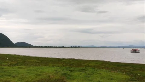 Panoramic Lake View with Distant Floating House and Mountain Range Stock Footage 344317883