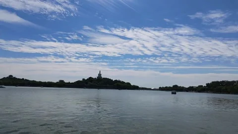 Panoramic Lake View with White Pagoda Under Blue Sky with Clouds Stock Footage 345470593
