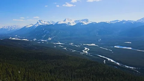 Panoramic landscape in Banff, Alberta features rugged mountain peaks, dark 스톡 동영상 334105382