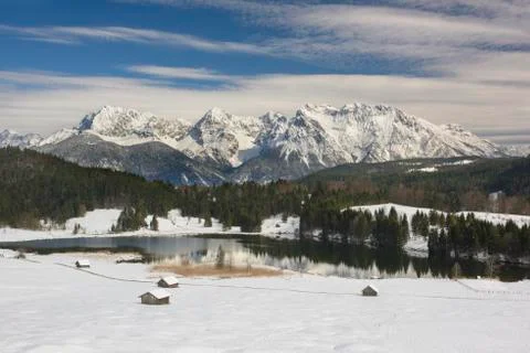 Panoramic landscape with mountain range and lake in winter Stock Photos