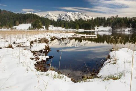 Panoramic landscape with mountain range and lake in winter Stock Photos