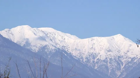 Panoramic landscape of mountain range under blue sky Stock Footage 62470062