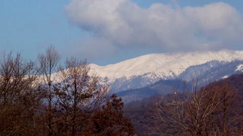 Panoramic landscape of mountain range under blue sky Stock Footage 62470184