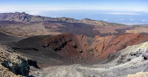 Panoramic landscape view over a red volcanic side crater and lava fields of T Stock Photos