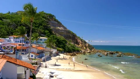 Panoramic of lighthouse, beach and guys playing soccer at Morro de Sao Paulo Stock Footage 150231472