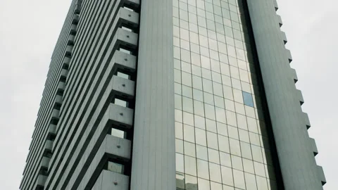 Panoramic Low-Angle View of Modern Skyscraper with Concrete and Glass Facade Stock Footage 309932586