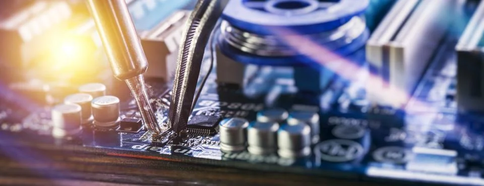 Panoramic macro view of soldering electronic components on computer motherboa Stock Photos