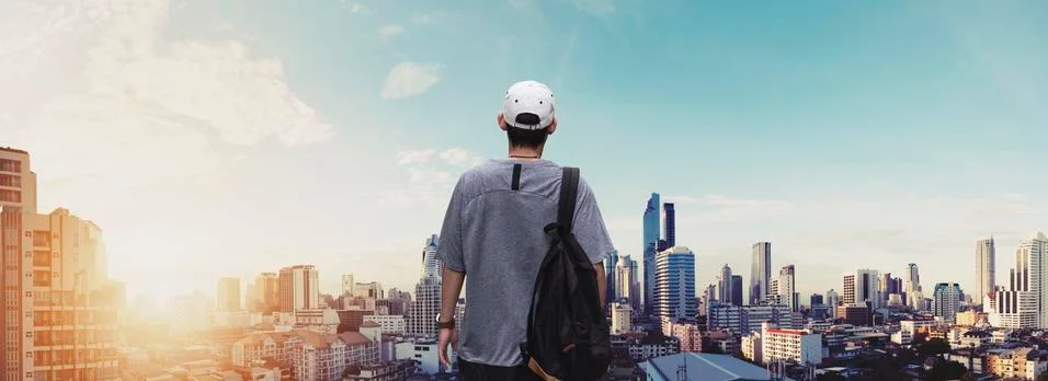 Panoramic a man with backpack standing at sightseeing city view in sunrise Stock Photos