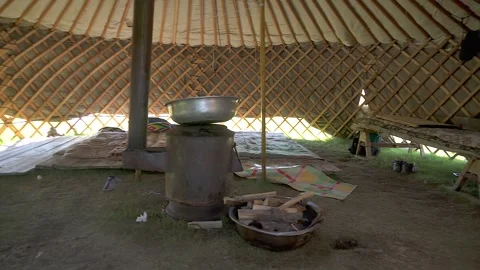 Panoramic Mongolian ger interior shows central stove - Wood Walls and Felt Tent Stock Footage 339709921