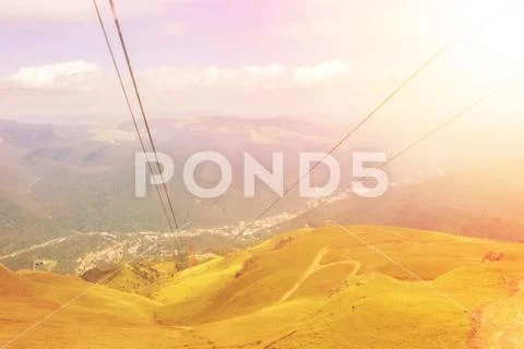 Panoramic morning sunset view from cableway cabin to Carpatian mountains, wal Stock Photos