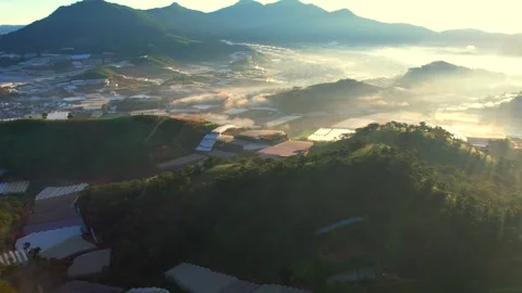 A panoramic morning view of Da Lat, featuring pine forests, greenhouses Stock Footage 310453918