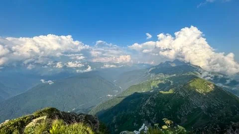 Panoramic mountain landscape with dramatic clouds and sunlight in the Caucasu Stock Photos