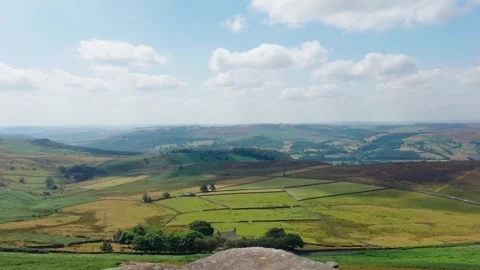 Panoramic mountain landscape with rolling green valleys beneath dramatic summer Stock Footage 341569099