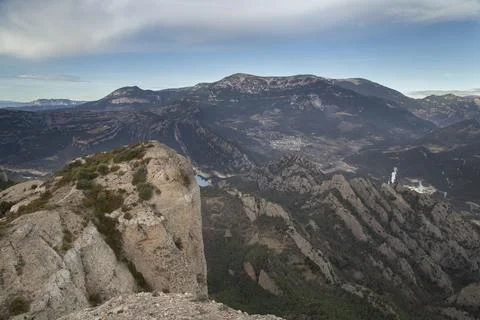Panoramic mountain landscape viewing deep valley and distant peaks Stock Photos