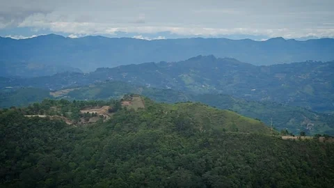 Panoramic mountain ridges with layered valleys under cloudy horizon Video stock 316790716