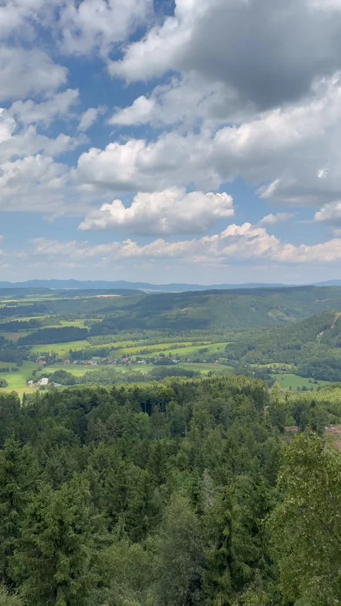 Panoramic mountain view on a clear summer day with scattered white clouds a.. Stock Footage 313663155