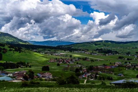Panoramic Mountain Village Under Dramatic Clouds Stock Photos