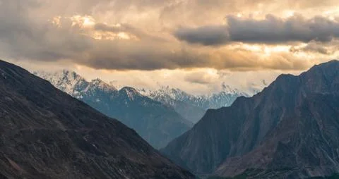 Panoramic mountains range landscape white overcast sky in sunrise, Pakistan Stock Photos
