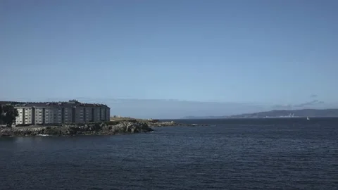 Panoramic movement of the camera on the sea surface, the opposite coast is Stock Footage 229505849
