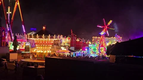 Panoramic Night View of a Carnival with Bright Rides and Carousel Stock Footage 341628745