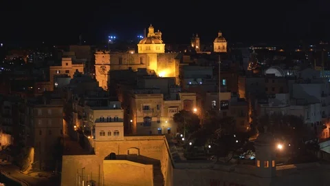 Panoramic night view of a coast line and the downtown of Valletta, Malta with Stock Footage 108688959