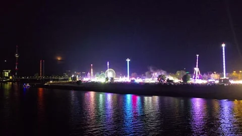 Panoramic Night View of a Fairground by the River with Colorful Reflections Stock Footage 341628874